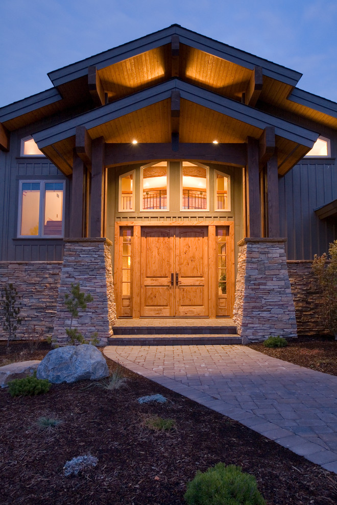 Large country front door in Other with a double front door and a medium wood front door.