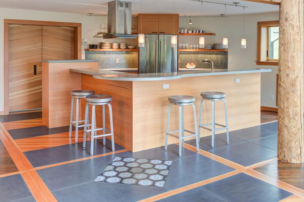 Photo of a mid-sized beach style open plan kitchen in San Francisco with light wood cabinets, zinc benchtops, glass tile splashback, stainless steel appliances, concrete floors, with island, multi-coloured floor, grey benchtop, open cabinets and multi-coloured splashback.
