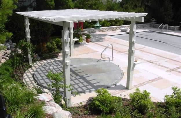 Inspiration for a large traditional backyard patio in Indianapolis with an outdoor shower, concrete pavers and a pergola.