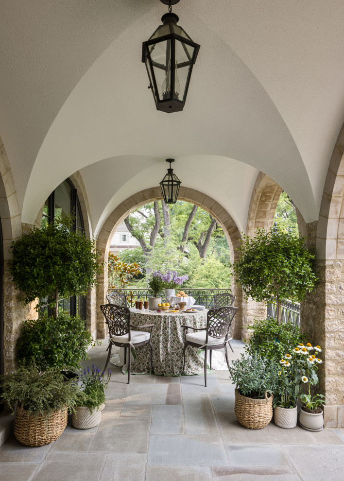 Patio - french country patio idea in Kansas City with a roof extension