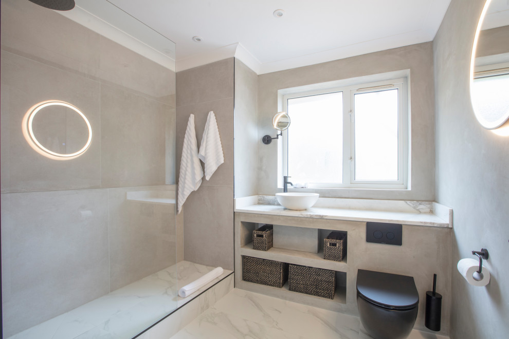 Inspiration for a mid-sized contemporary bathroom in London with grey cabinets, an open shower, gray tile, cement tile, grey walls, marble benchtops, white floor, an open shower, white benchtops, a niche, a single vanity and a built-in vanity.