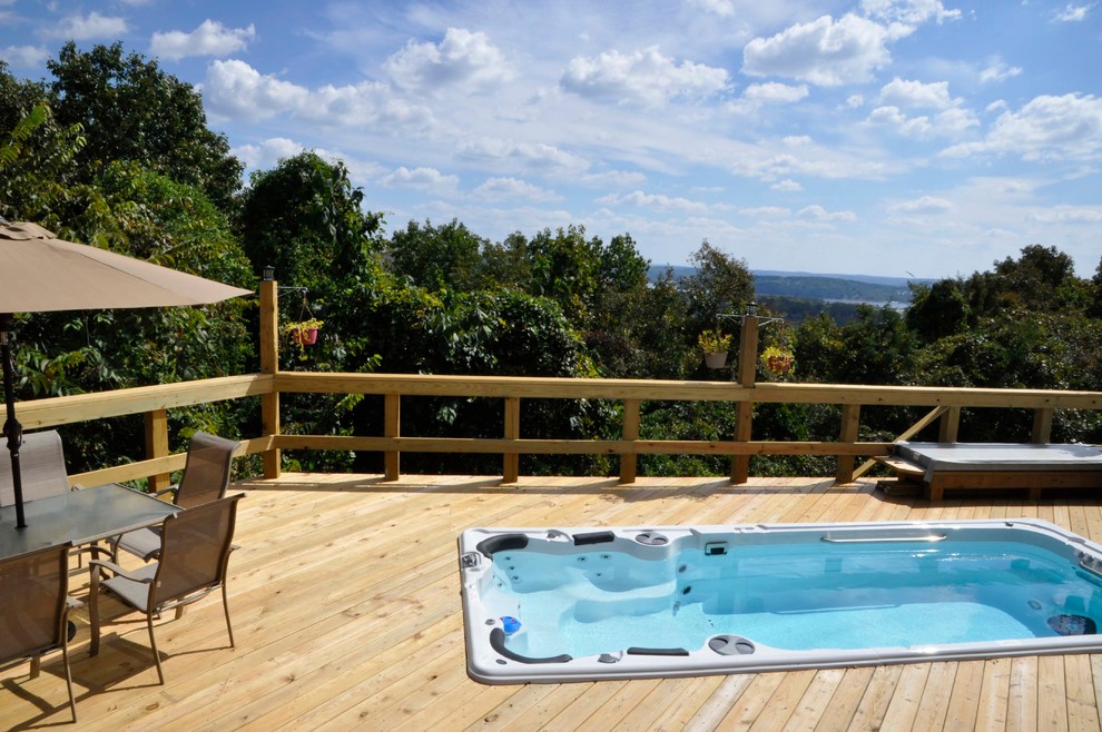 Mid-sized mountain style rooftop rectangular hot tub photo with decking