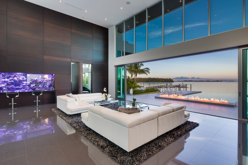 This is an example of a contemporary open concept living room in Miami with marble floors.