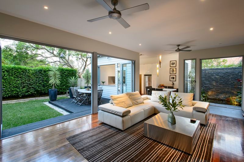 Mid-sized contemporary open concept living room in Sydney with beige walls and medium hardwood floors.
