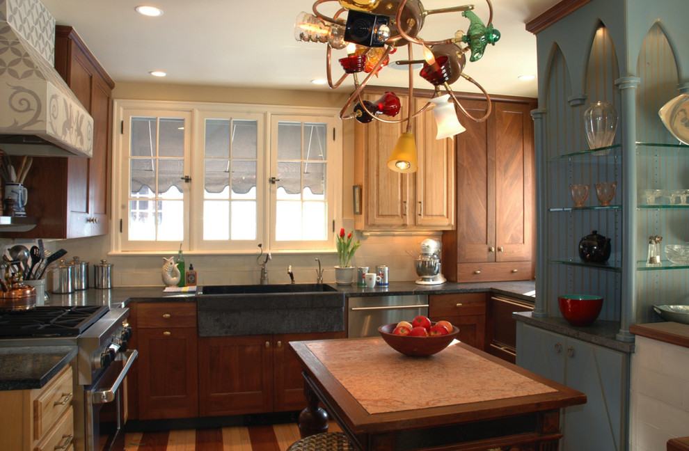 Inspiration for a mid-sized transitional u-shaped light wood floor enclosed kitchen remodel with a farmhouse sink, recessed-panel cabinets, soapstone countertops, white backsplash, cement tile backsplash, stainless steel appliances, white walls, an island and light wood cabinets