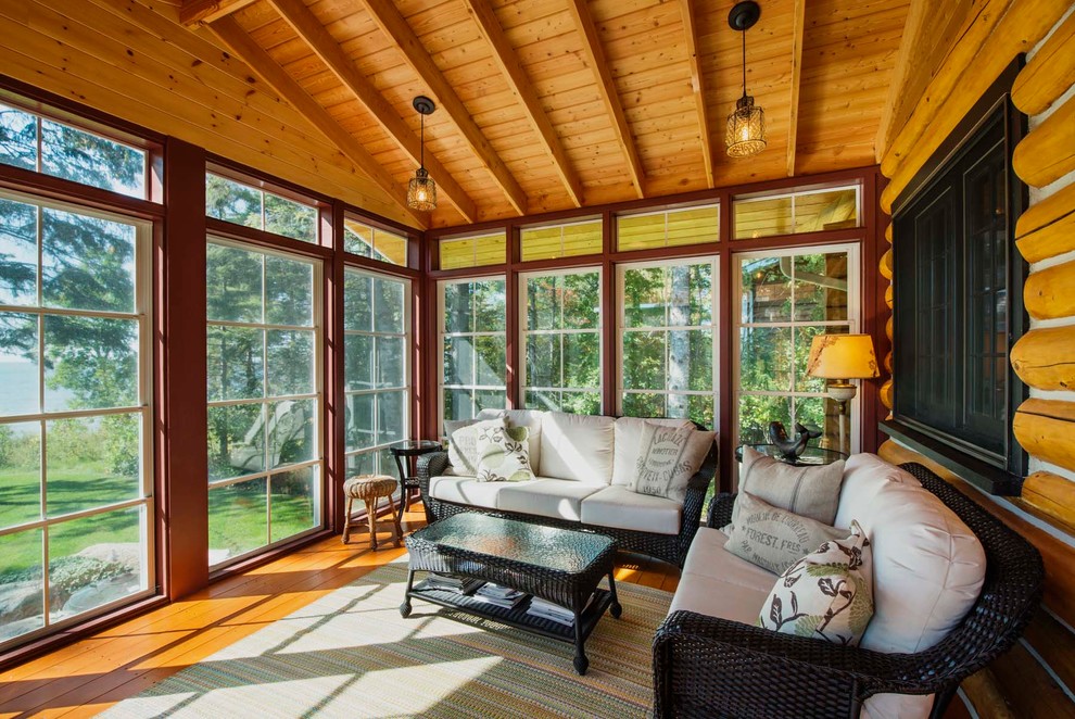 Inspiration for a large rustic medium tone wood floor and brown floor sunroom remodel with no fireplace and a standard ceiling