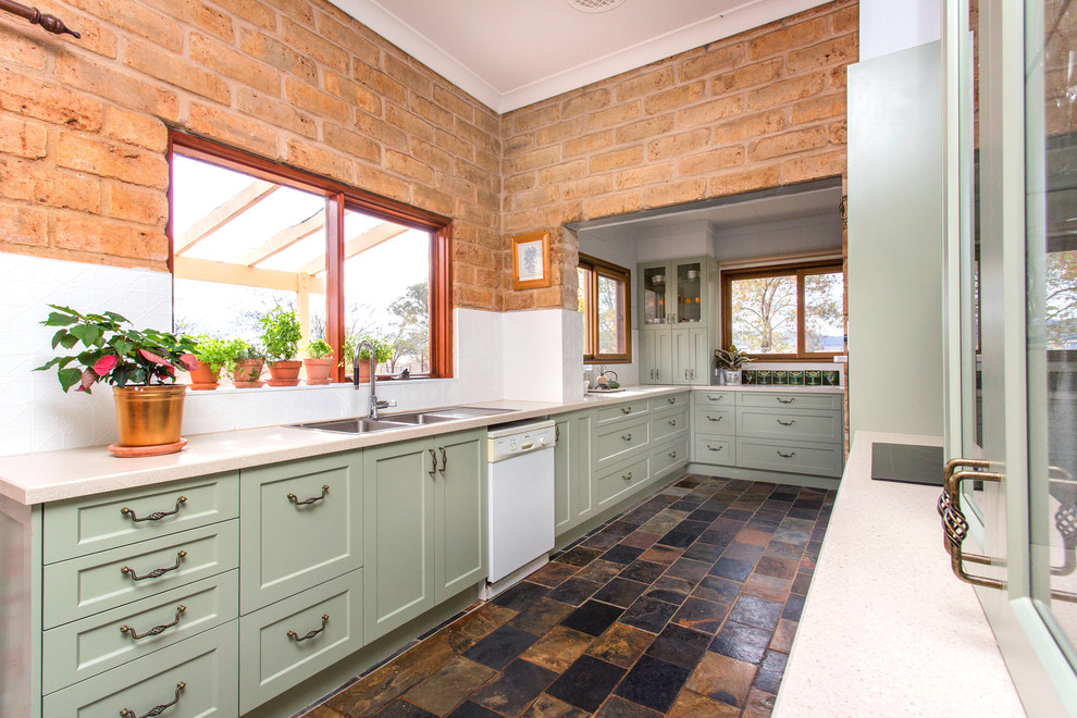Design ideas for a small country galley kitchen in Other with a double-bowl sink, shaker cabinets, green cabinets, solid surface benchtops, white splashback, metal splashback, slate floors, multi-coloured floor and beige benchtop.
