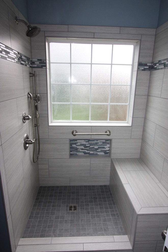 Mid-sized trendy master gray tile and porcelain tile porcelain tile doorless shower photo in Other with recessed-panel cabinets, white cabinets, a two-piece toilet, blue walls, an undermount sink and granite countertops