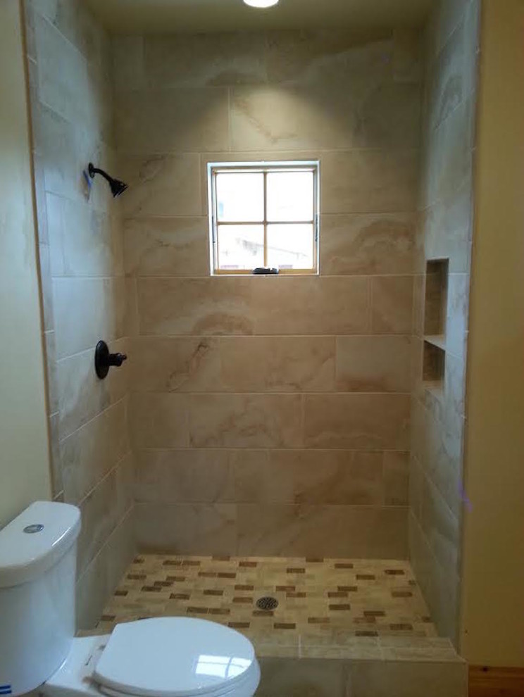 Inspiration for a transitional beige tile and porcelain tile alcove shower remodel in Denver with a two-piece toilet and yellow walls