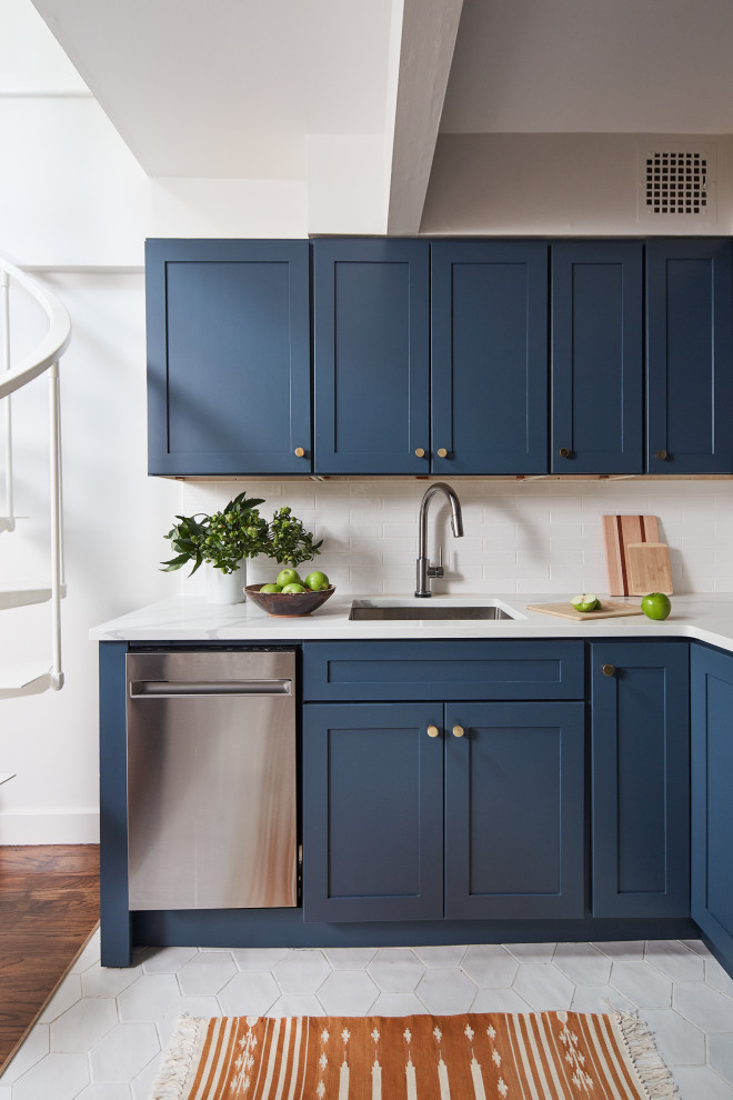 Design ideas for a small transitional l-shaped eat-in kitchen in New York with an undermount sink, shaker cabinets, blue cabinets, quartz benchtops, white splashback, subway tile splashback, stainless steel appliances, ceramic floors, no island, white floor and white benchtop.
