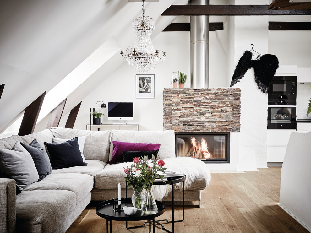 This is an example of a large scandinavian formal living room in Gothenburg with white walls, a ribbon fireplace, no tv and light hardwood floors.