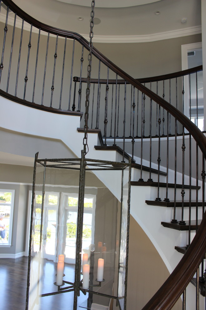 Inspiration for an expansive beach style wood spiral staircase in Other with wood risers and mixed railing.