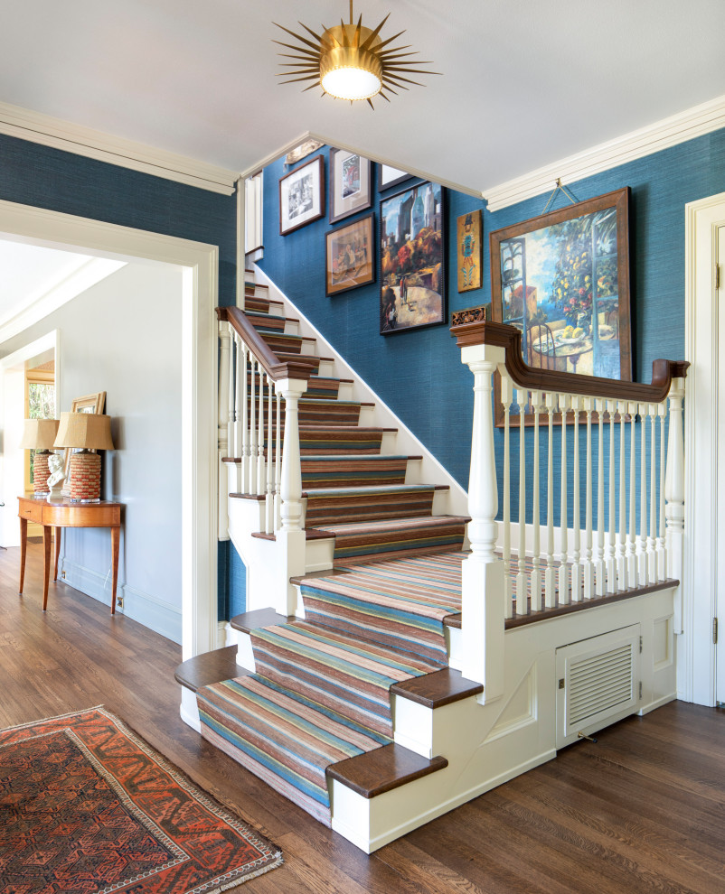 Inspiration for a traditional carpeted l-shaped staircase in Portland with carpet risers and wood railing.