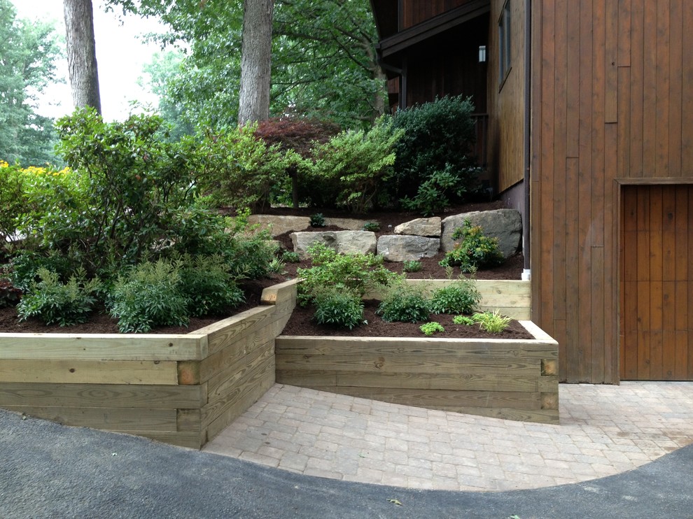 Design ideas for a rustic partial sun hillside retaining wall landscape.