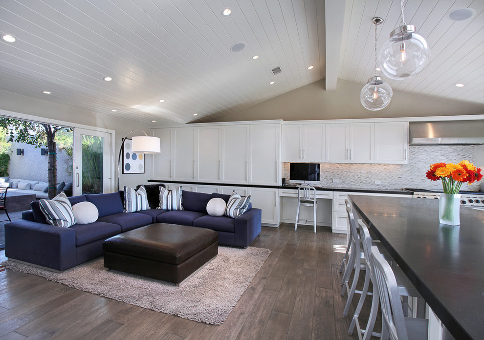 Photo of a transitional open concept living room in Orange County with beige walls and grey floor.