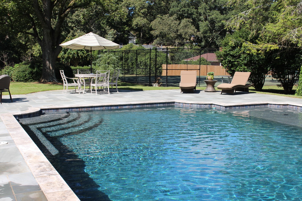 Photo of a large traditional backyard rectangular pool in Atlanta with a pool house.