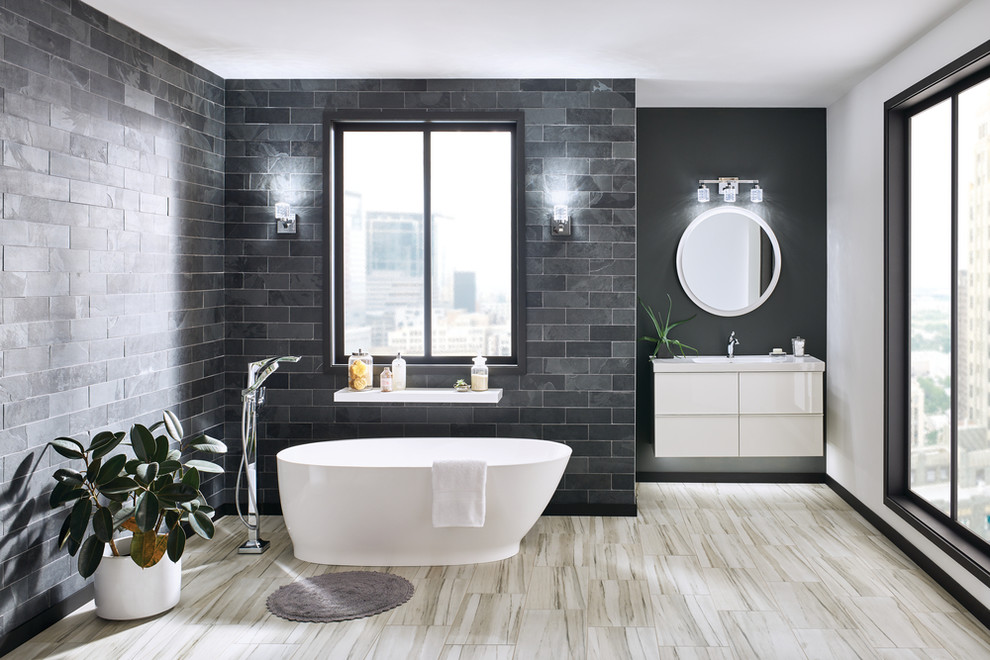 Large modern master bathroom in Other with flat-panel cabinets, white cabinets, a freestanding tub, gray tile, stone tile, white walls, an integrated sink, solid surface benchtops, beige floor and white benchtops.