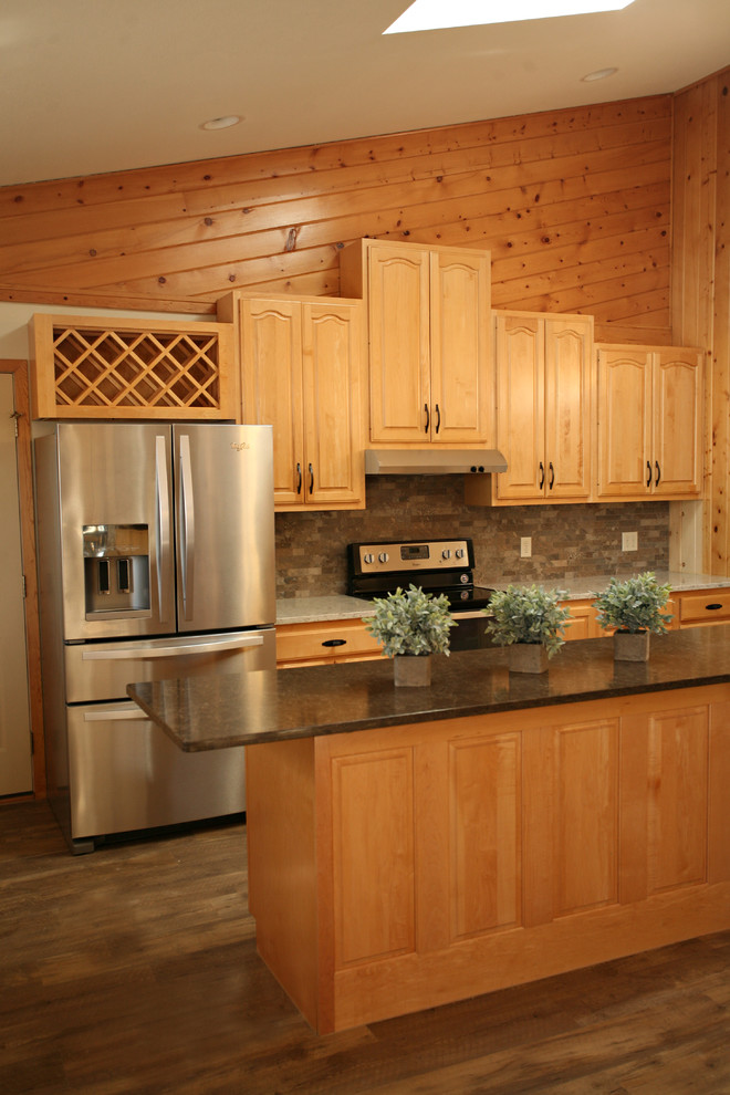 Inspiration for a mid-sized rustic l-shaped medium tone wood floor and brown floor open concept kitchen remodel with a double-bowl sink, raised-panel cabinets, light wood cabinets, quartz countertops, gray backsplash, stone tile backsplash, stainless steel appliances and an island