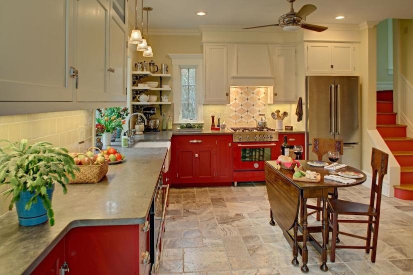 Inspiration for a traditional l-shaped eat-in kitchen in New York with red cabinets, a farmhouse sink, beaded inset cabinets, limestone benchtops, yellow splashback, ceramic splashback and coloured appliances.