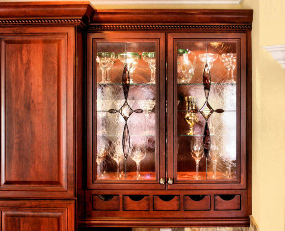 This is an example of a traditional kitchen in Miami with glass-front cabinets.