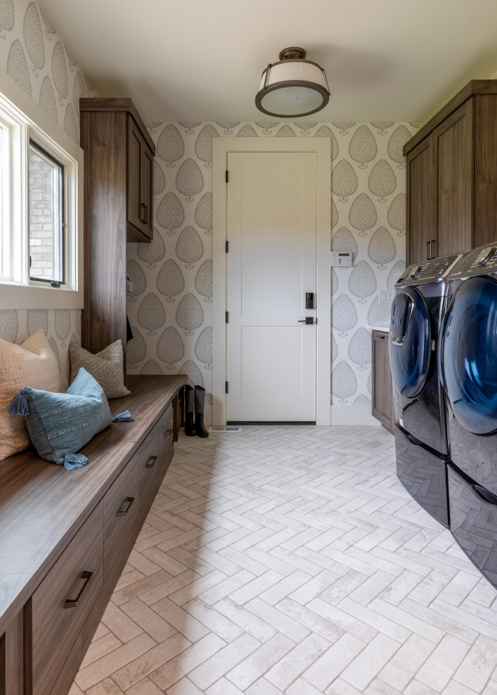 This is an example of a large beach style galley utility room in Denver with an undermount sink, shaker cabinets, grey cabinets, ceramic floors, a side-by-side washer and dryer, white floor and wallpaper.