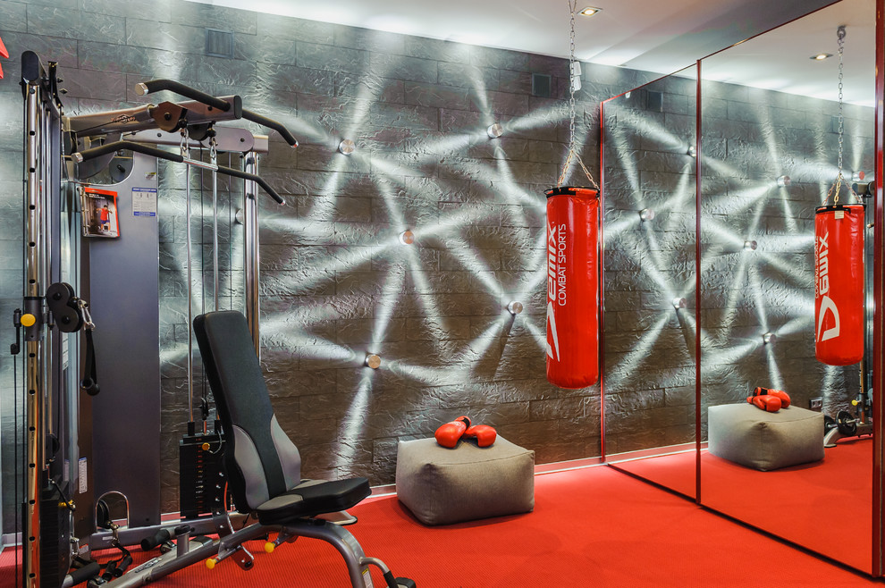 This is an example of a contemporary home weight room in Moscow with grey walls.