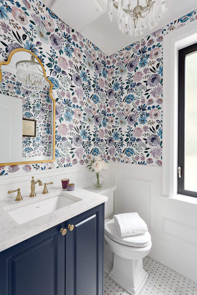 Inspiration for a small traditional powder room in Vancouver with recessed-panel cabinets, blue cabinets, a two-piece toilet, mosaic tile floors, an undermount sink, engineered quartz benchtops, white floor, white benchtops and multi-coloured walls.