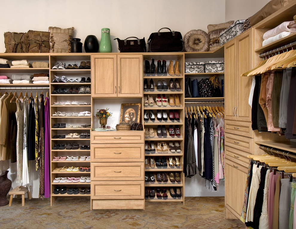 Inspiration for a mid-sized traditional gender-neutral walk-in wardrobe in Orange County with flat-panel cabinets, light wood cabinets, carpet and brown floor.