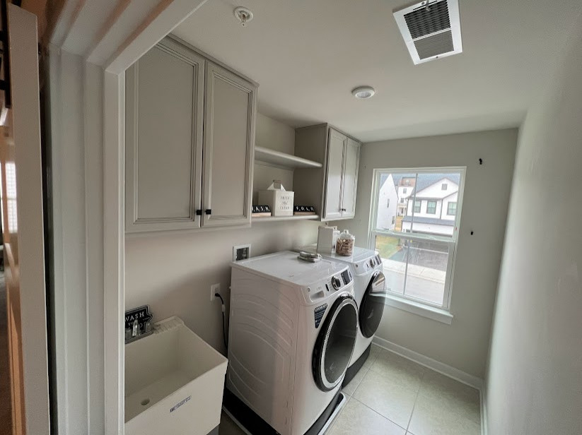 Design ideas for a small traditional single-wall dedicated laundry room in Baltimore with an utility sink, beaded inset cabinets, grey cabinets, grey walls, porcelain floors, a side-by-side washer and dryer and beige floor.