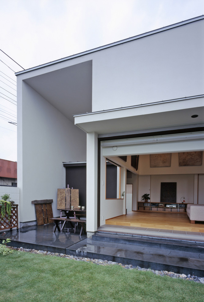 Inspiration for a mid-sized contemporary side yard verandah in Other with an outdoor kitchen, concrete pavers and a roof extension.