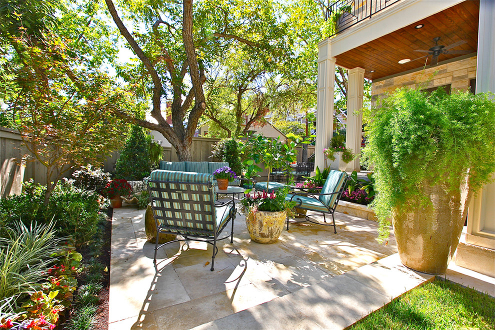 This is an example of a contemporary patio in Austin with natural stone pavers.