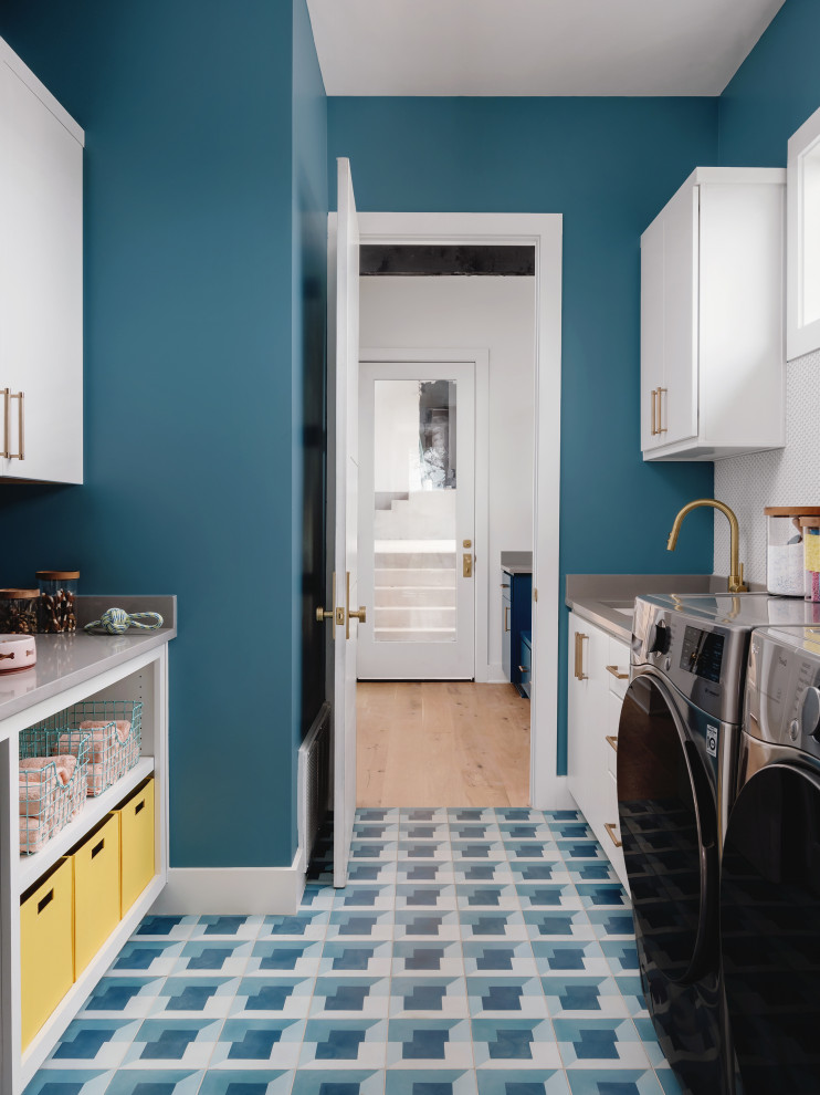 Photo of a mid-sized midcentury galley dedicated laundry room in Austin with shaker cabinets, white cabinets, quartz benchtops, ceramic floors, blue floor and grey benchtop.