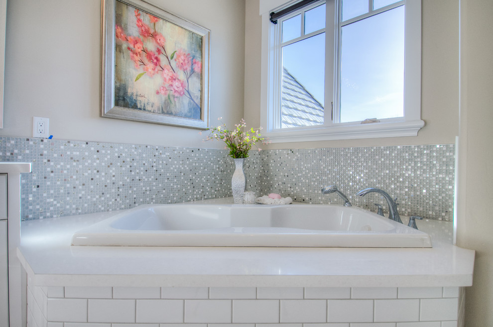 This is an example of a large traditional kids bathroom in Salt Lake City with an undermount sink, recessed-panel cabinets, white cabinets, engineered quartz benchtops, a drop-in tub, an alcove shower, a one-piece toilet, white tile, ceramic tile, grey walls and ceramic floors.