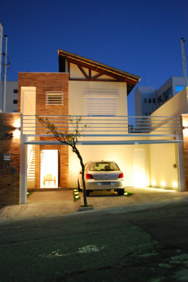 This is an example of a small contemporary two-storey brick beige exterior in Other.