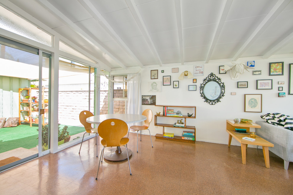 Photo of a midcentury dining room in Orange County with white walls.