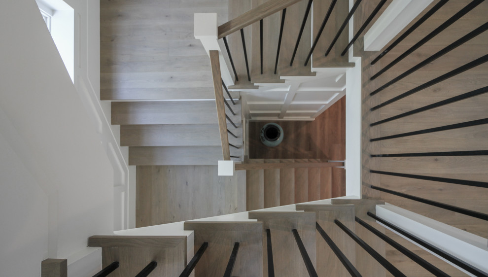 Inspiration for a large classic wood u-shaped wood railing staircase in DC Metro with wood risers and wainscoting.