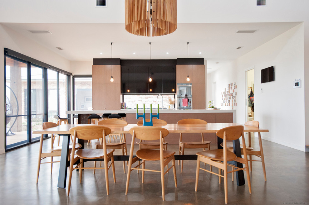 Inspiration for a contemporary kitchen/dining combo in Melbourne with white walls, concrete floors and no fireplace.