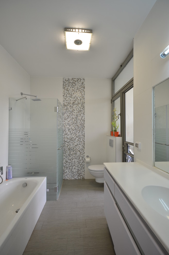 Inspiration for a contemporary bathroom in Tel Aviv with a freestanding tub and white benchtops.