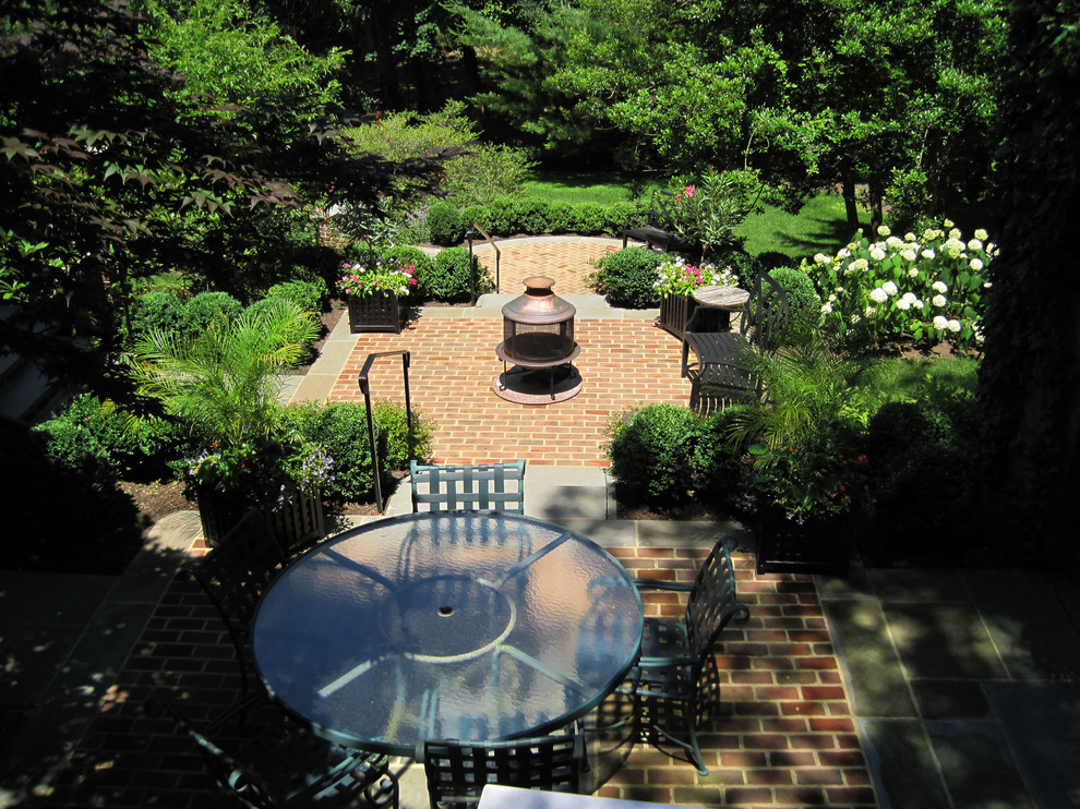 This is an example of a traditional patio in Philadelphia with brick pavers and a fire feature.