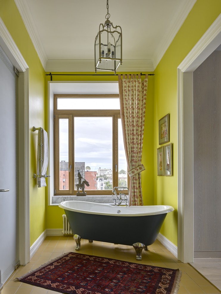Inspiration for an eclectic master bathroom in Moscow with a claw-foot tub, yellow walls and ceramic floors.