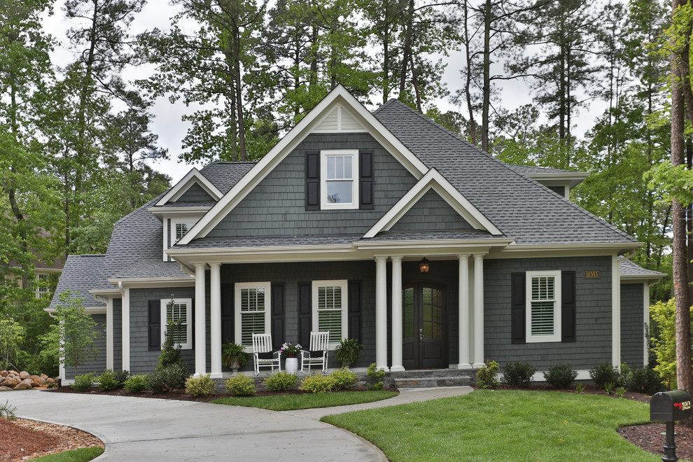 Large transitional two-storey grey house exterior in Raleigh with wood siding, a hip roof and a shingle roof.