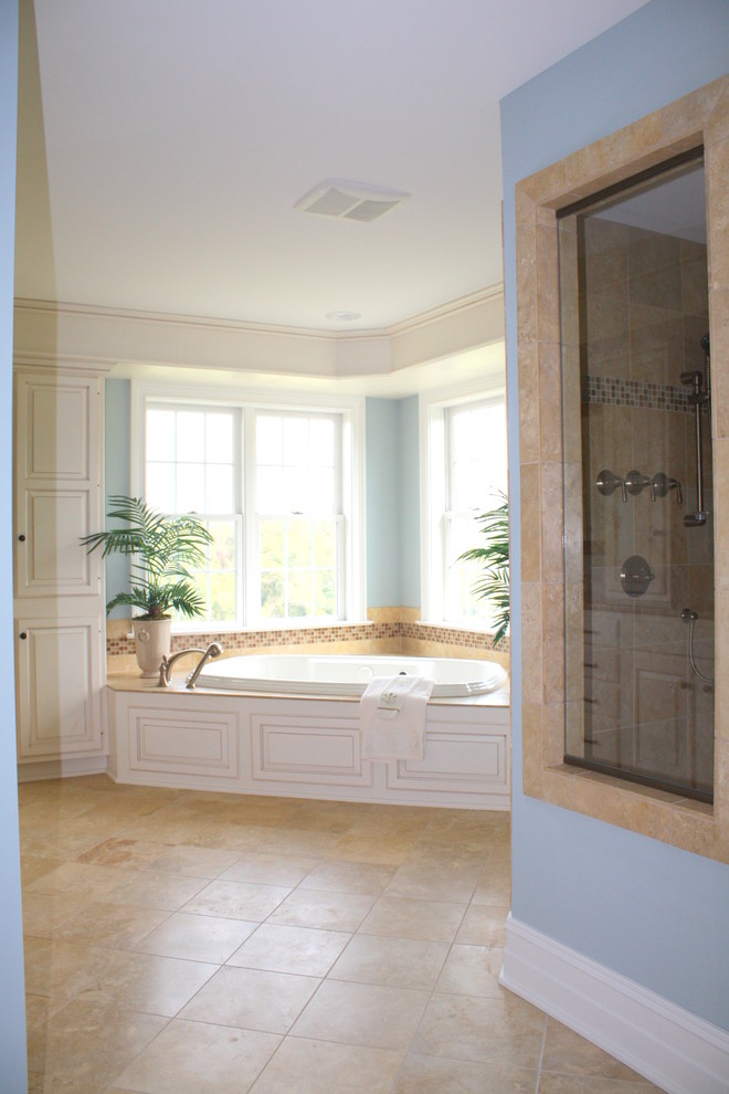 Example of a large transitional master porcelain tile and multicolored floor drop-in bathtub design with raised-panel cabinets, white cabinets, blue walls, an undermount sink and quartz countertops