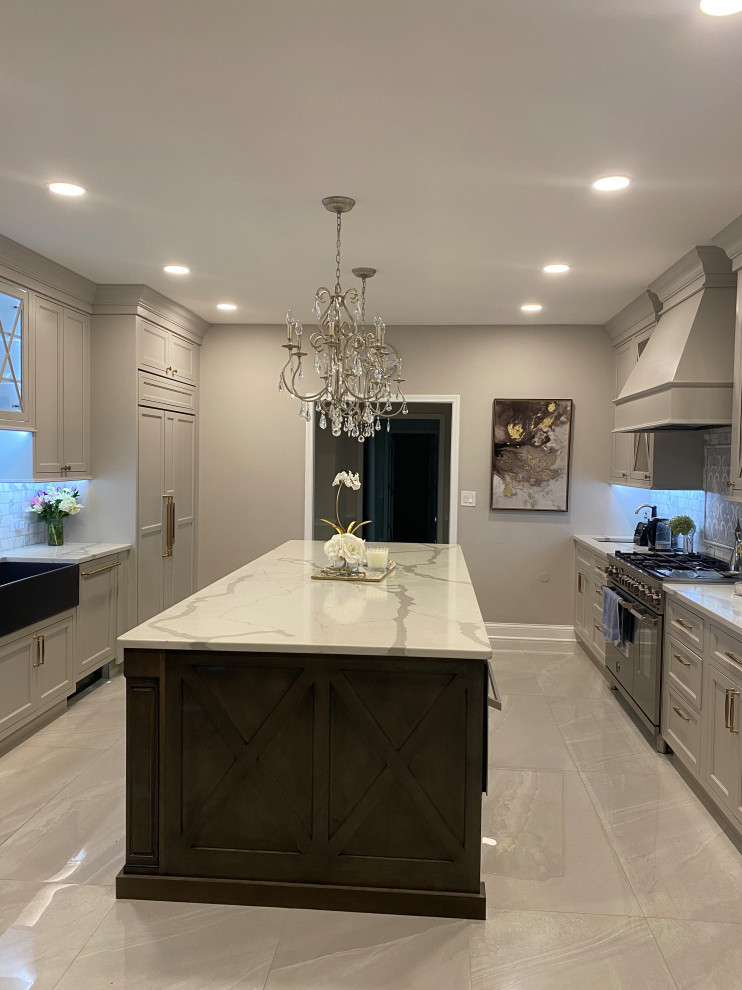Large transitional kitchen pantry in Chicago with a farmhouse sink, beaded inset cabinets, grey cabinets, quartz benchtops, white splashback, marble splashback, stainless steel appliances, porcelain floors, with island, grey floor and white benchtop.