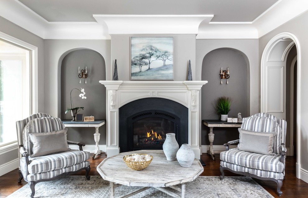 Inspiration for a traditional enclosed living room in Sacramento with grey walls, a standard fireplace, a metal fireplace surround, dark hardwood floors and brown floor.