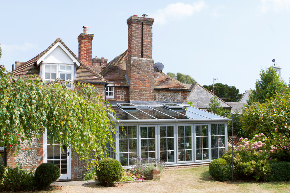 Inspiration for a medium sized traditional conservatory in Sussex with a glass ceiling.