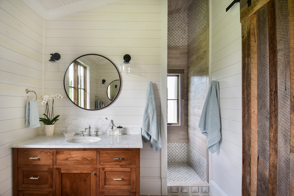 Inspiration for a country master bathroom in Other with shaker cabinets, medium wood cabinets, white walls, mosaic tile floors, an undermount sink, marble benchtops, white floor, an open shower, white benchtops and an alcove shower.
