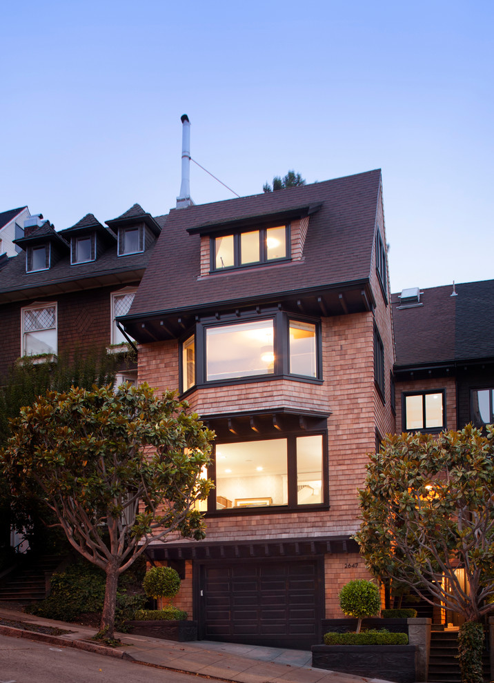 Photo of a large traditional three-storey house exterior in San Francisco with wood siding.