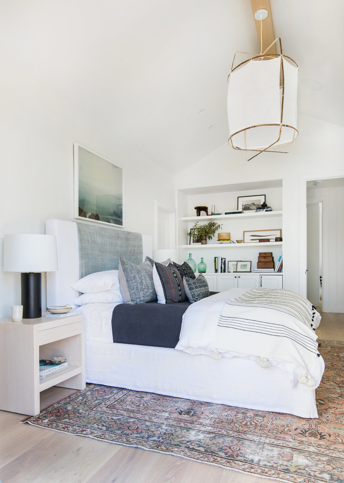 Large transitional master bedroom in San Diego with white walls, light hardwood floors, no fireplace and beige floor.