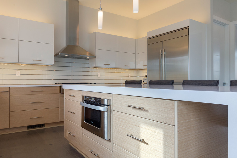 Photo of a large modern u-shaped eat-in kitchen in Other with an undermount sink, open cabinets, white cabinets, quartzite benchtops, white splashback, glass tile splashback, stainless steel appliances, dark hardwood floors and with island.