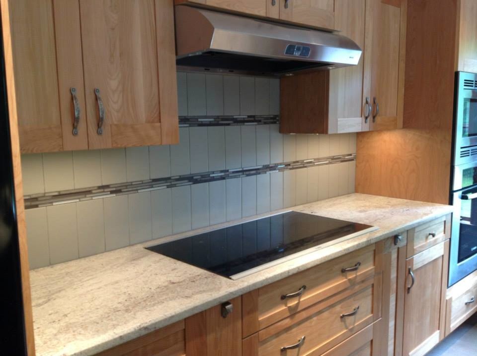 Example of a single-wall open concept kitchen design in Bridgeport with recessed-panel cabinets, light wood cabinets, granite countertops, multicolored backsplash, matchstick tile backsplash and stainless steel appliances